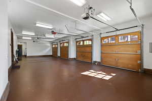 Garage with baseboards and a garage door opener