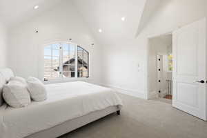 apartment Bedroom with baseboards, recessed lighting, high vaulted ceiling, and carpet