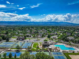 Drone / aerial view of a mountainous background and a pool area