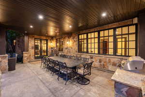 View of patio / terrace featuring exterior kitchen, french doors, and outdoor dining space