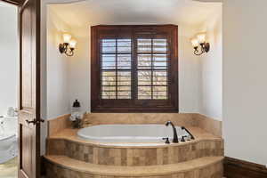 Bathroom featuring toilet and a bath