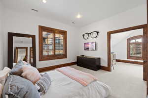 Carpeted bedroom with visible vents, baseboards, and recessed lighting