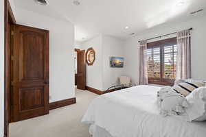 Bedroom featuring light carpet, baseboards, visible vents, and recessed lighting