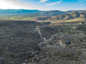 Aerial view of property and surrounding area with mountains