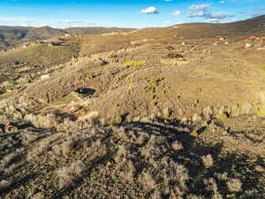 Aerial view of property and surrounding area with mountains