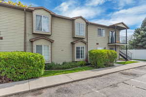Townhome / multi-family property featuring stairs, a balcony, and fence