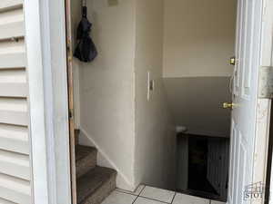 Staircase featuring tile patterned flooring