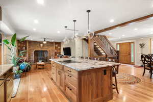 Kitchen featuring open floor plan, recessed lighting, white oak hardwood floorings, a large island, and ceiling fan