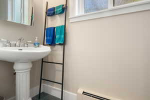 Half bathroom with baseboards, and a sink