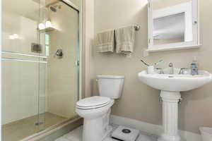 Bathroom with toilet and a stall shower