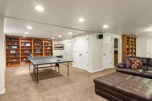 Recreation room featuring carpet, recessed lighting, and baseboards