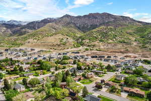 Aerial overview of property's location featuring a mountain backdrop and nearby suburban area