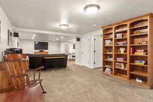 Family room featuring carpet floors, a textured ceiling, recessed lighting, and baseboards