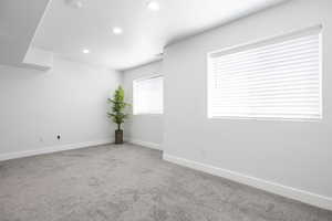 Spare room with carpet floors, recessed lighting, baseboards, and a smoke detector