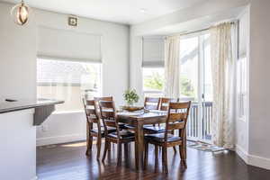 Dining space featuring plenty of natural light, wood finished floors, and baseboards