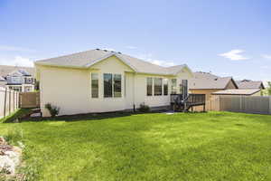 Back of property featuring stucco siding and a shingled roof