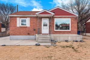 Bungalow-style home featuring brick siding and entry steps