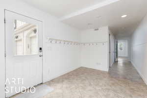 Interior space featuring light tile patterned floors, visible vents, baseboards, and recessed lighting