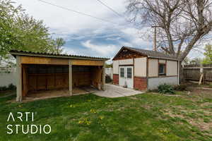 View of outbuilding featuring an outdoor structure and fence