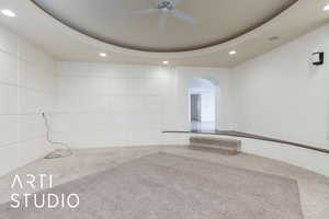 Spare room featuring carpet floors, arched walkways, a ceiling fan, and recessed lighting