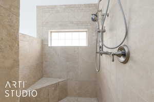 Full bath featuring a tile shower