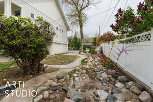View of yard with a garage and fence