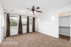 Unfurnished bedroom featuring baseboards, a ceiling fan, visible vents, and carpet