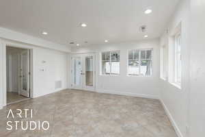 Unfurnished room with french doors, visible vents, and recessed lighting