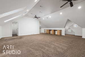 Additional living space with lofted ceiling with skylight, visible vents, ceiling fan, and carpet