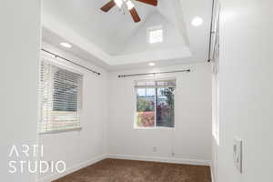 Spare room with a wealth of natural light, baseboards, ceiling fan, and carpet floors
