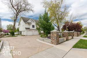 View of home's exterior with an attached garage, a shingled roof, and driveway
