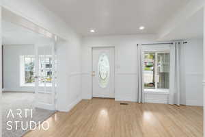 Foyer featuring recessed lighting, baseboards, visible vents, and wood finished floors
