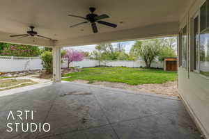 View of patio with a ceiling fan and a fenced backyard