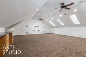 Bonus room featuring baseboards, lofted ceiling with skylight, ceiling fan, and carpet floors