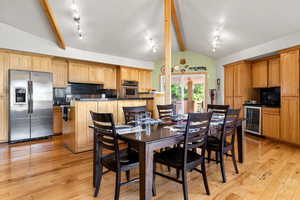 Dining space with wine cooler and hickory wood flooring