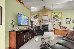 Living area with healthy amount of natural light, a fireplace, and carpet floors