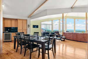 Dining room with wine cooler and hickory hardwood finished floors