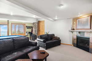 Carpeted family room featuring a fireplace, and baseboards