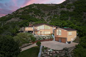 Front of house at dusk with a detached garage, accessory apartment, and mountain and valley views