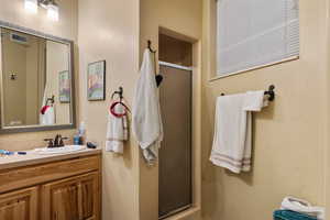 Full bathroom with a stall shower and vanity