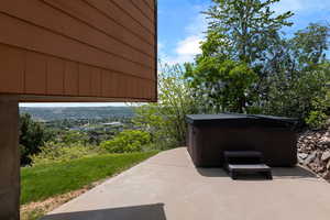 View of patio / terrace featuring a hot tub with valley views