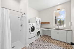 Laundry room off garage equipped with shower and double hookups