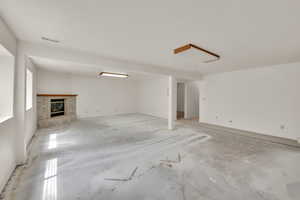 Unfurnished living room with a brick fireplace
