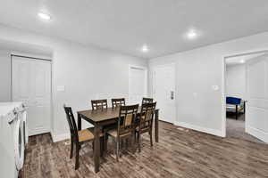 Dining room featuring washing machine and dryer, dark wood-style flooring, recessed lighting, and baseboards