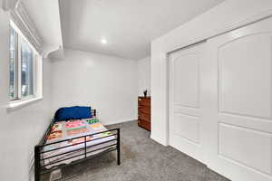 Carpeted bedroom with recessed lighting and baseboards