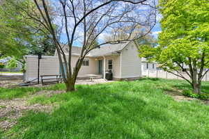 Back of property with fence and a patio area
