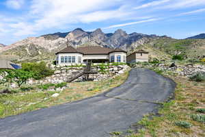 Single story home with stairway and a mountain view