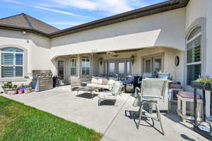 View of patio / terrace featuring ceiling fan, an outdoor hangout area, french doors, and a grill