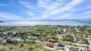 Birds eye view of property featuring a water and mountain view
