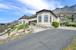 View of front of house featuring stucco siding and a mountain view